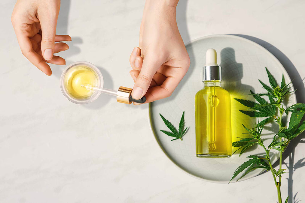 Cannabis oil and dropper with a few leaves